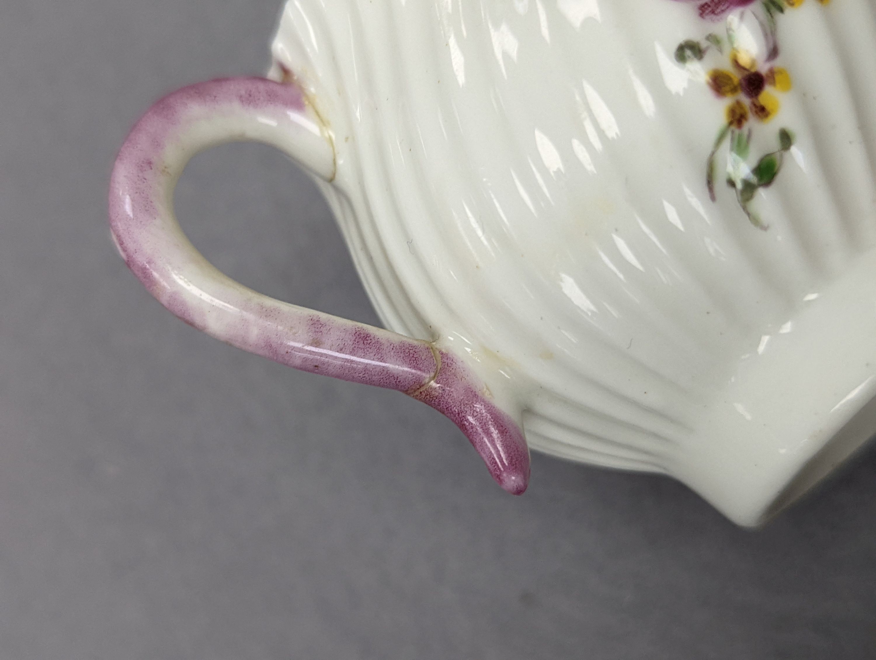 An 18th century Mennecy porcelain cup and cover, a Meissen style cup and cover, an English porcelain floral encrusted double inkwell and cover and a similar jar and cover